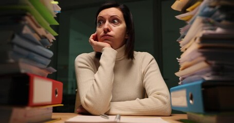 Woman overloaded with tasks connected with documents in folders