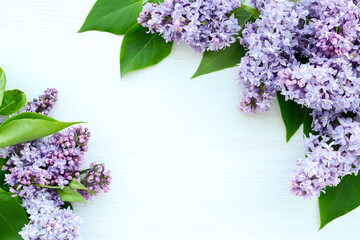 Lilac flowers on white wooden background. Spring flowers. Beautiful Floral background for Birthday,...