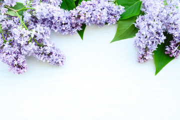 Lilac flowers on white wooden background. Spring flowers. Flat lay, top view, copy space. Beautiful...