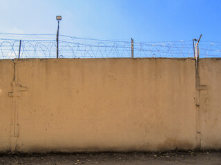 Prison wall with barbed wire