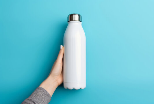 The white and silver water bottle on a blue background, styled with bold chromaticity.