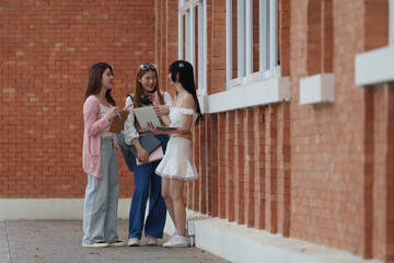 Asian teenage student and friends talking and enjoying at university. back to school concept