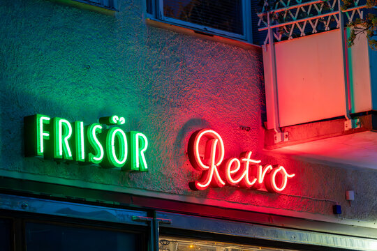 Stockholm, Sweden  A red and green neon sign in the Hokarangen suburb say in Swedish ,Hair salon and Retro.
