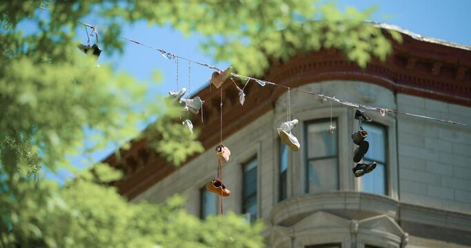 Sunny Day in Harlem NYC with Shoes Tossed Over Wire Next to Apartment Building