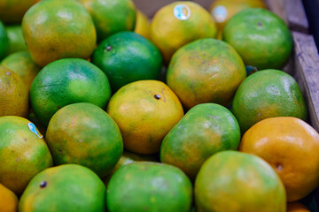 Fresh green tangerine for sale at market