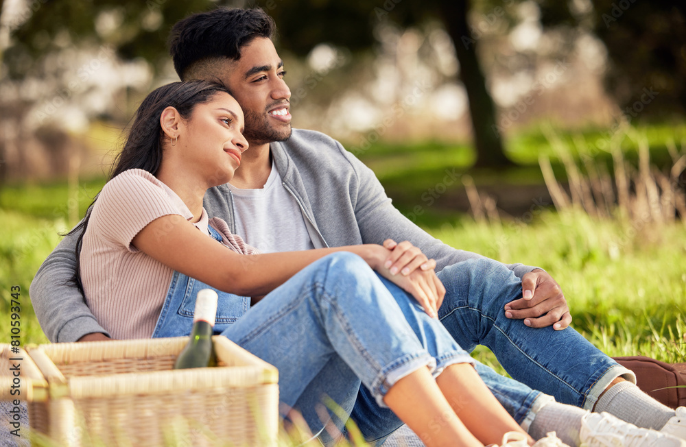 Canvas Prints Couple, picnic and basket on grass for love with celebrate anniversary, alcohol and together with relax. Woman, man and happiness in nature with smile, wine bottle and weekend date for relationship