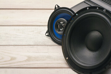 Modern car audio stereo speakers on the workbench background. Car stereo renew concept.