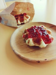 Breakfast of waffle with strawberry jam