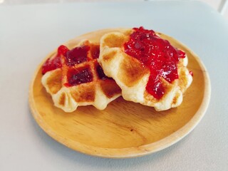 Breakfast of waffle with strawberry jam