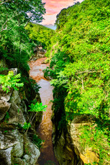 Beautiful natural scenery of turbulent muddy water flowing through rock channel in Op Luang National Park