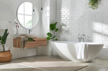 A bright bathroom with white tiles on the walls, concrete floor and light wood furniture
