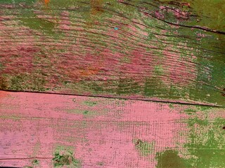 Green-pink wooden fence background. Close-up wall or floor wooden green pink plank panel or board...
