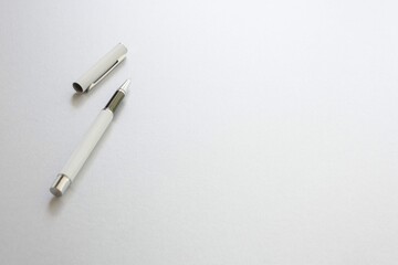 White pen isolated white writing paper background