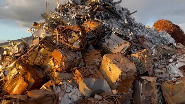 View of metal scrap yard in Japan. Bunch of old rusty metal in sunset. Recycling concept video.