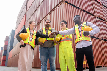 group of multiracial cargo container workers in safety uniform holding hardhat,doing hands stacked at container yard,concept of container shipping in export and import business and logistics