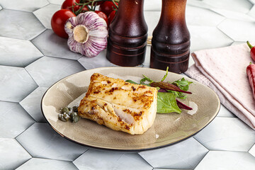 Roasted cod fish steak with salad