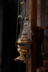 Church incense soars from a golden censer