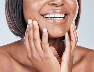 African woman, mouth and lipstick in studio with smile for beauty, results and cosmetics by...