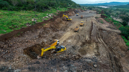 Grader, Excavator, and Dump Trucks Preparing Construction Site © selcukbulbul