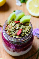 Yogurt parfait with matcha granola and chia seeds berry jam  