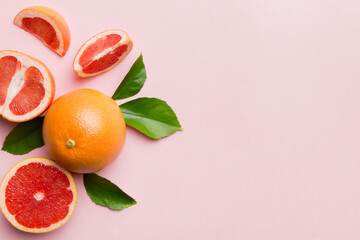 fresh Fruit grapefruit with Juicy grapefruit slices on colored background. Top view. Copy Space. creative summer concept. Half of citrus in minimal flat lay with copy space