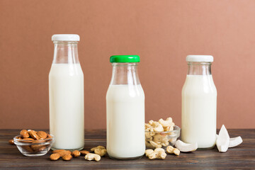 Set or collection of various vegan milk almond, coconut, cashew, on table background. Vegan plant...