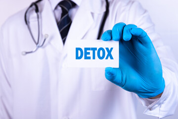 Doctor holding a card with DETOX Medical concept