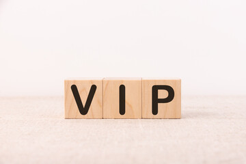 Word VIP made with wood building blocks on a light background
