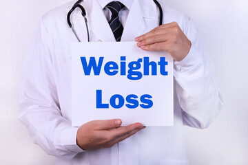 Doctor holding a card with Weight loss medical concept