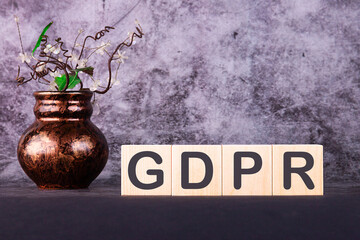 Word GDPR made with wood building blocks on a gray background