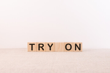 TRY ON word concept written on wooden cubes blocks lying on a light table and light background