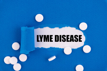 The text Lyme Disease appearing behind torn blue paper.