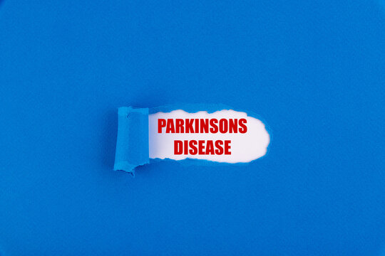 The text Parkinsons disease appearing behind torn blue paper.