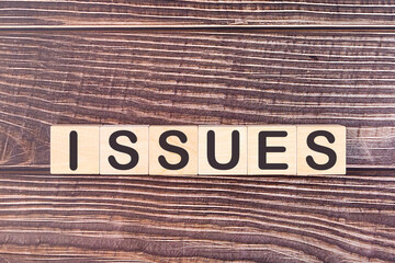 ISSUES word made with wood building blocks