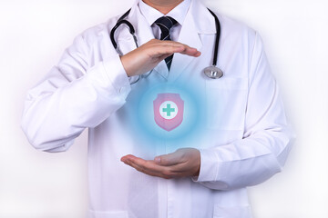 Health insurance concept. A doctor with a stethoscope holds his hands as a symbol of protection.