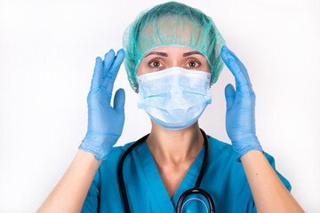 Closeup woman portrait of a doctor, surgeon or nurse surprised starring with big eyes, wearing a...