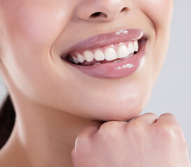 Happy woman, mouth and teeth with confidence for dental care, hygiene or treatment on a gray studio background. Closeup of young female person with big smile for tooth whiteneing, lip gloss or glow