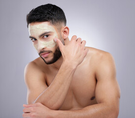 Face, mask and man with skincare in studio, portrait and grey background with dermatology. Healthy,...