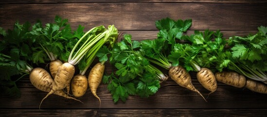 A rustic wooden table is adorned with a bountiful display of fresh ripe parsnips and vibrant green leaves This delightful arrangement forms a flat lay leaving ample space for the addition of text - Powered by Adobe