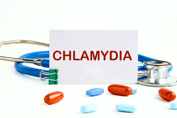 Medical concept. Word Chlamydia. on a white business card on a white background next to a...