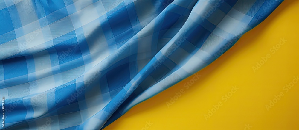 Aufkleber There is an empty background with a checkered fabric material in blue and yellow The copy space image is available