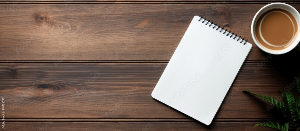 Poster A copy space image of a notebook styled with a tablet and coffee placed on a wooden surface