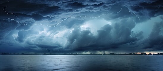 Fototapeta premium A background image of the cloudy and stormy sky preceding rain. Creative banner. Copyspace image
