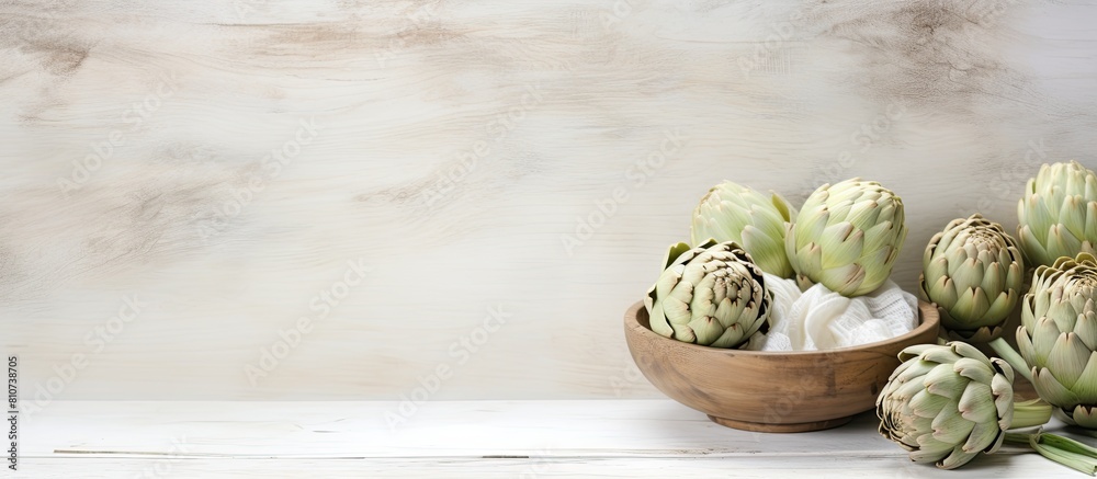 Poster The white wooden table is adorned with a bowl filled with powder and fresh artichokes creating an appealing flat lay composition Ample space is available for text