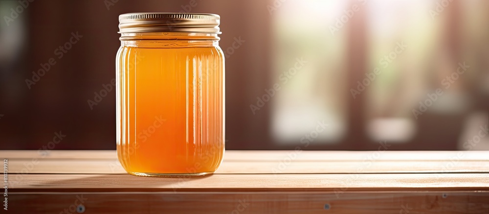 Poster A refreshing and flavorful mason jar filled with juice is placed on a table indoors leaving ample space for text in the image