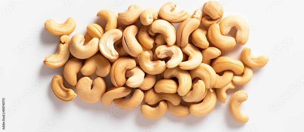 Aufkleber A pile of cashew nuts on a white background seen from above with empty space for additional elements