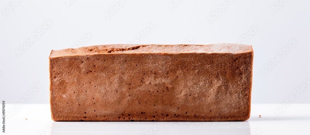 Poster a copy space image of a rye flour bread brick with spices placed on a white background