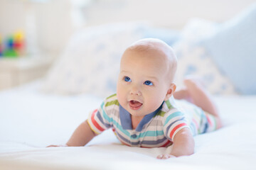 Little baby on white bed