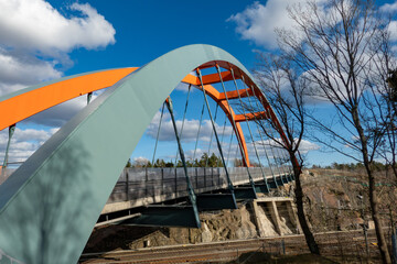 Stockholm, Sweden  An orange and blue-colored bridge over the railroad tracks in the Vastberga...