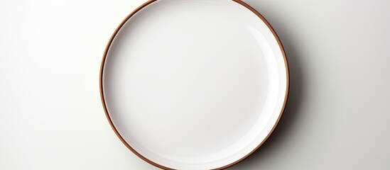 A plate with no food on it placed alone on a blank white background leaving space for the image....